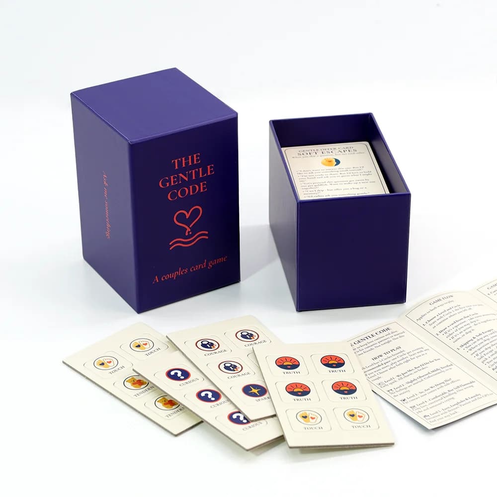 The Gentle Code box with all game components beautifully arranged - tokens, cards, and instructions